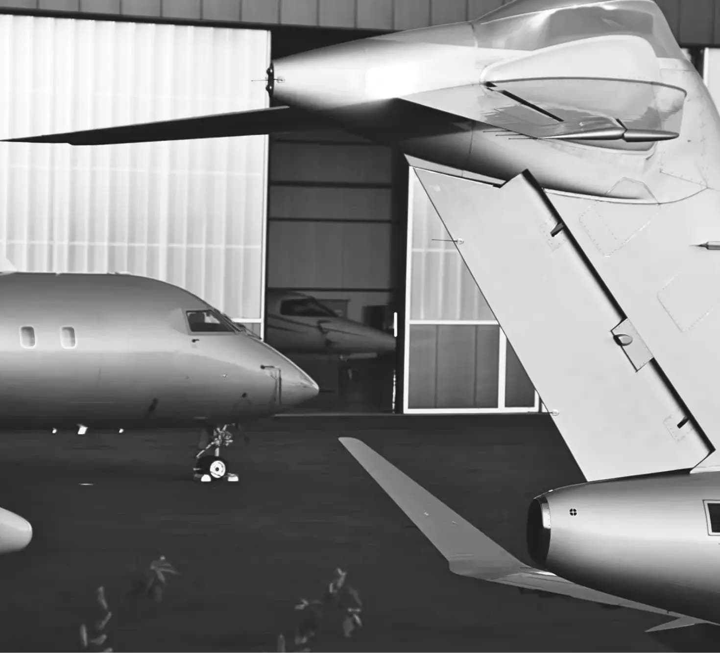 Jet nose with another jet's back in a hangar